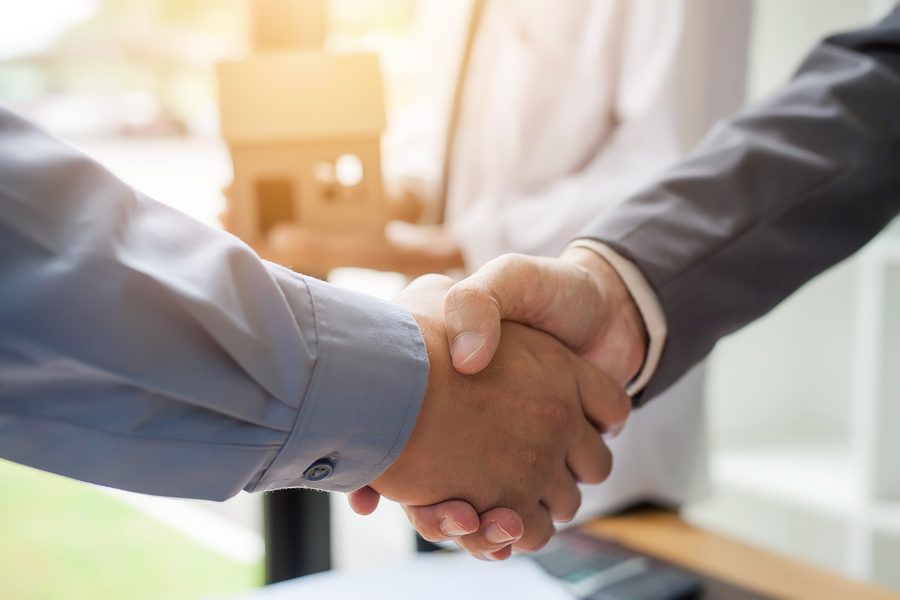 Business man shaking hands during a meeting in the office, Signing of the real estate sale agreement between buyer and broker